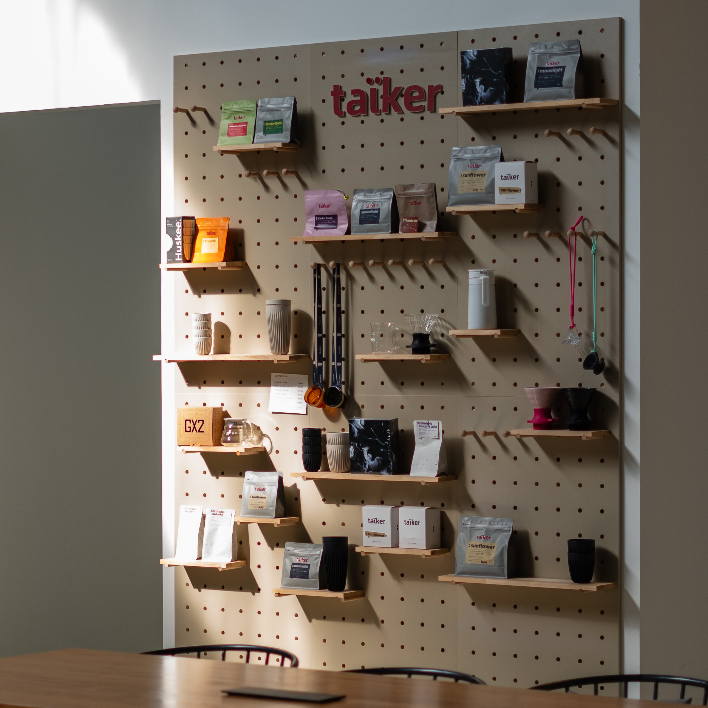 taïker retail wall — whole bean, drip bag and accessories on display